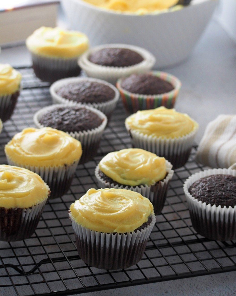 Frosting the chocolate cupcakes with the yema cream.