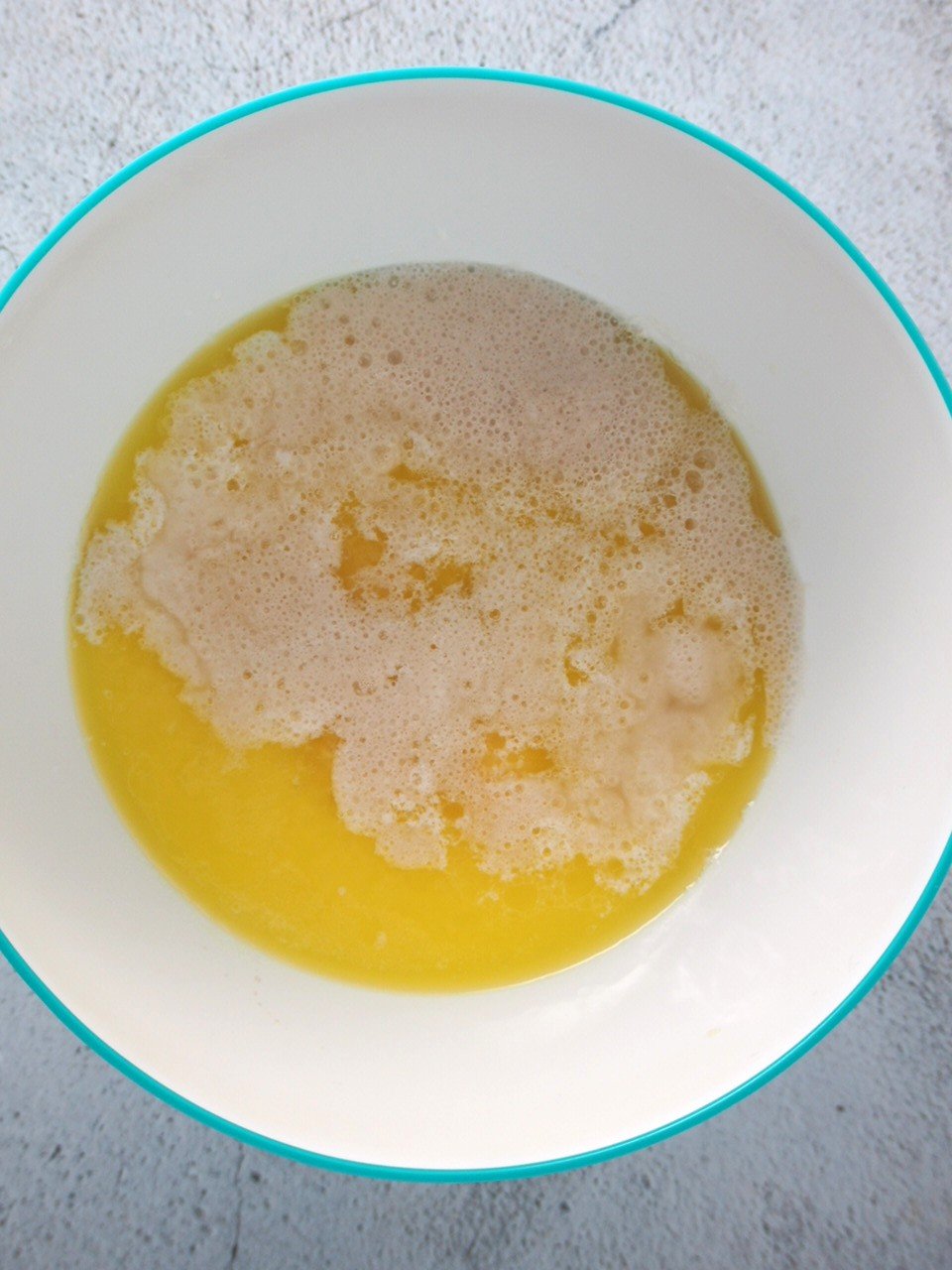 The egg, milk, butter, sugar and salt is added to the yeast mixture.