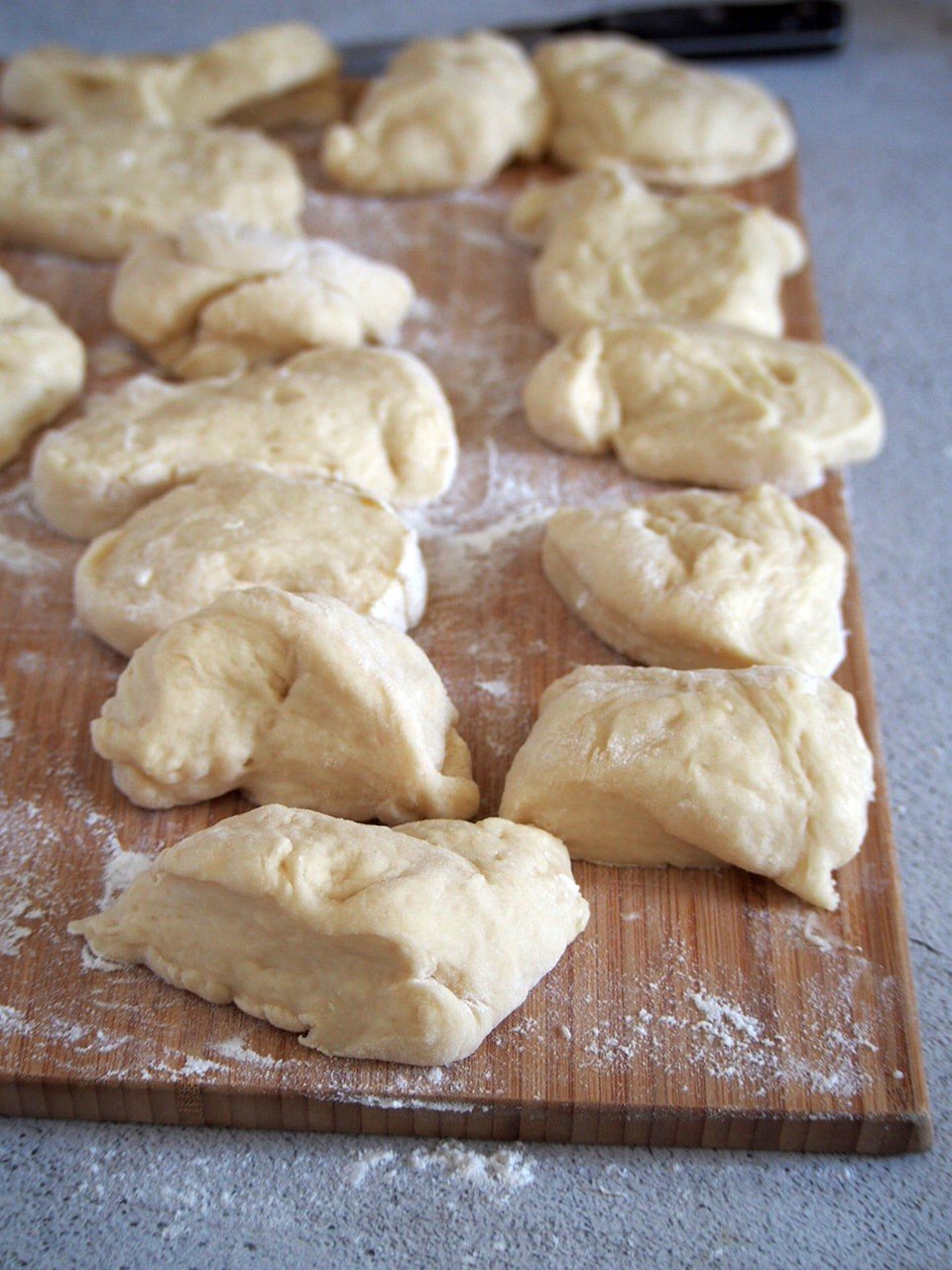 The risen dough of Pan de Leche, divided into 14 portions.