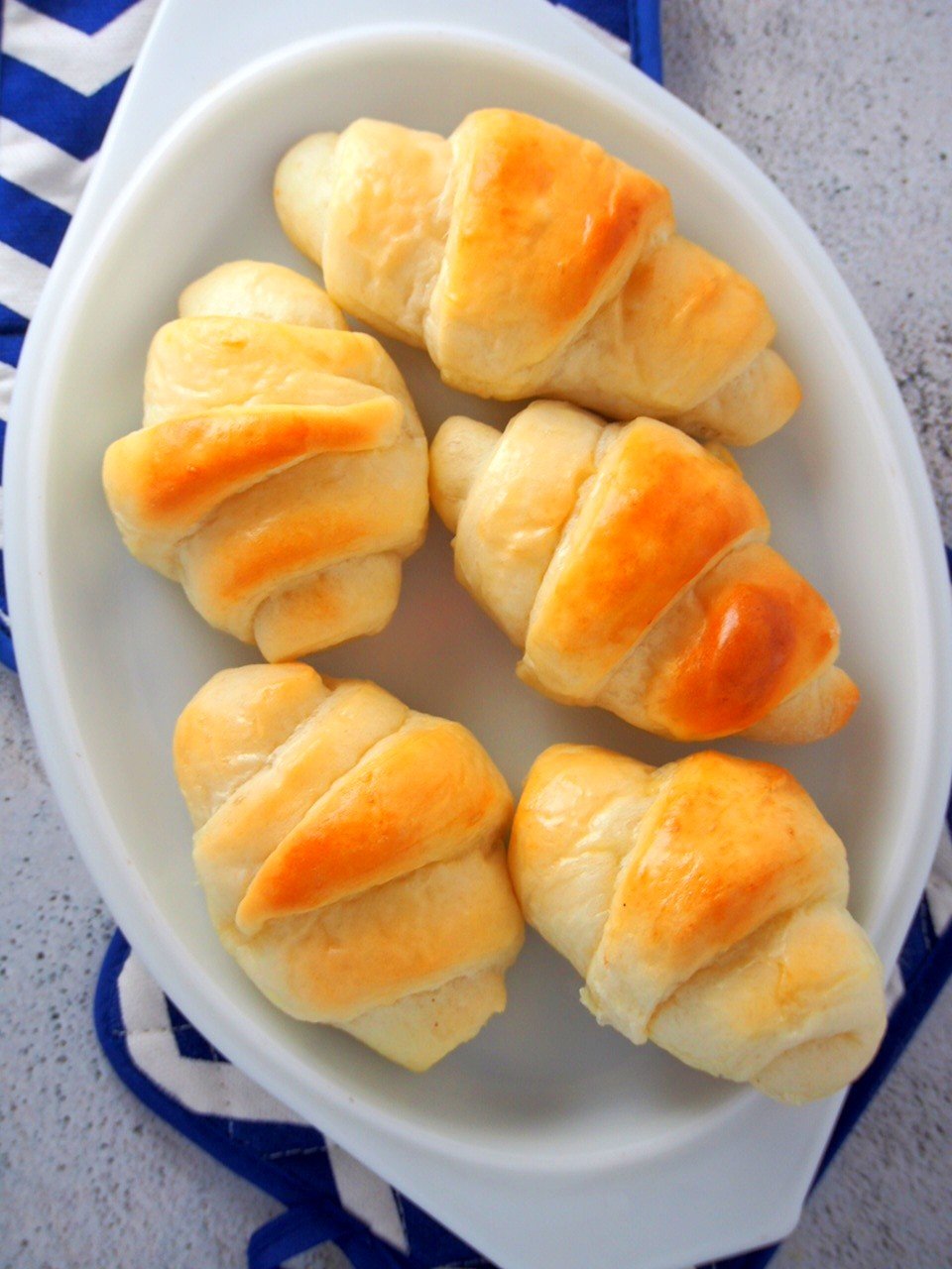 Top angle shot of Salted butter rolls on a serving dish.