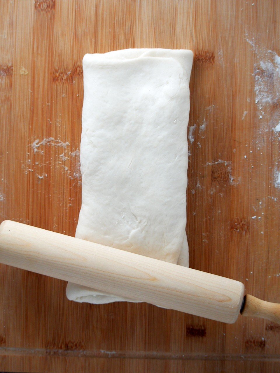 Rolling the bread dough into a rectangle.