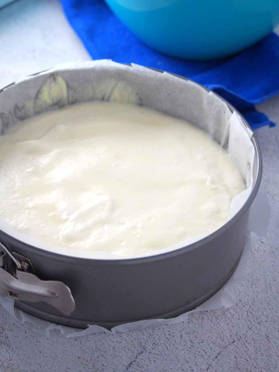 The cheesecake batter poured into the prepared baking pan.