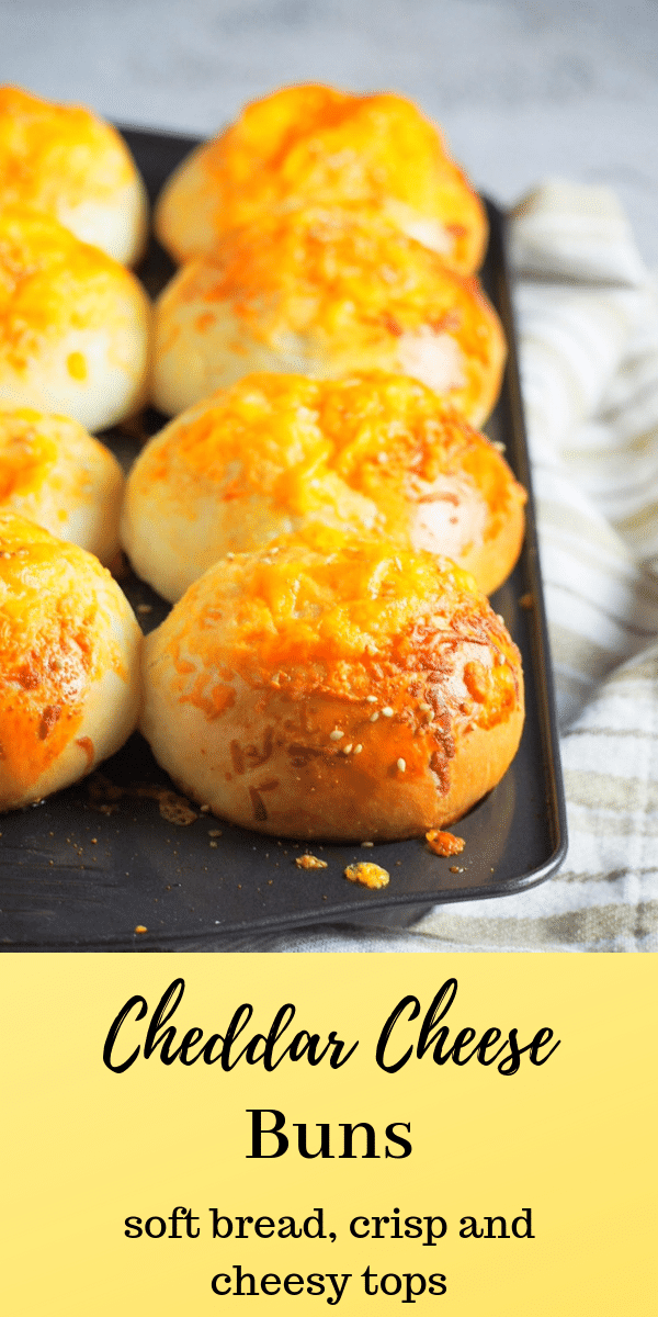 Tender crisp and cheesy tops with hints of garlic flavor, You will love these Cheddar Cheese Buns that has a bit of parmesan cheese mixed in the toppings. #cheese #cheddarbread #cheesebread