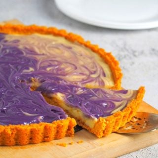 Ube Custard tart with one slice ready for serving.