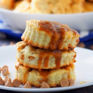 Salted Caramel Scones stacked in a plate and surrounded by caramel chips.