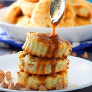 Drizzling caramel sauce on top of the stacked salted caramel scones.