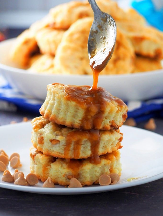 Drizzling caramel sauce on top of the stacked salted caramel scones.