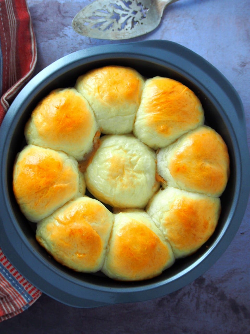 Top shot angle of dulce de leche bread rolls in a baking pan.