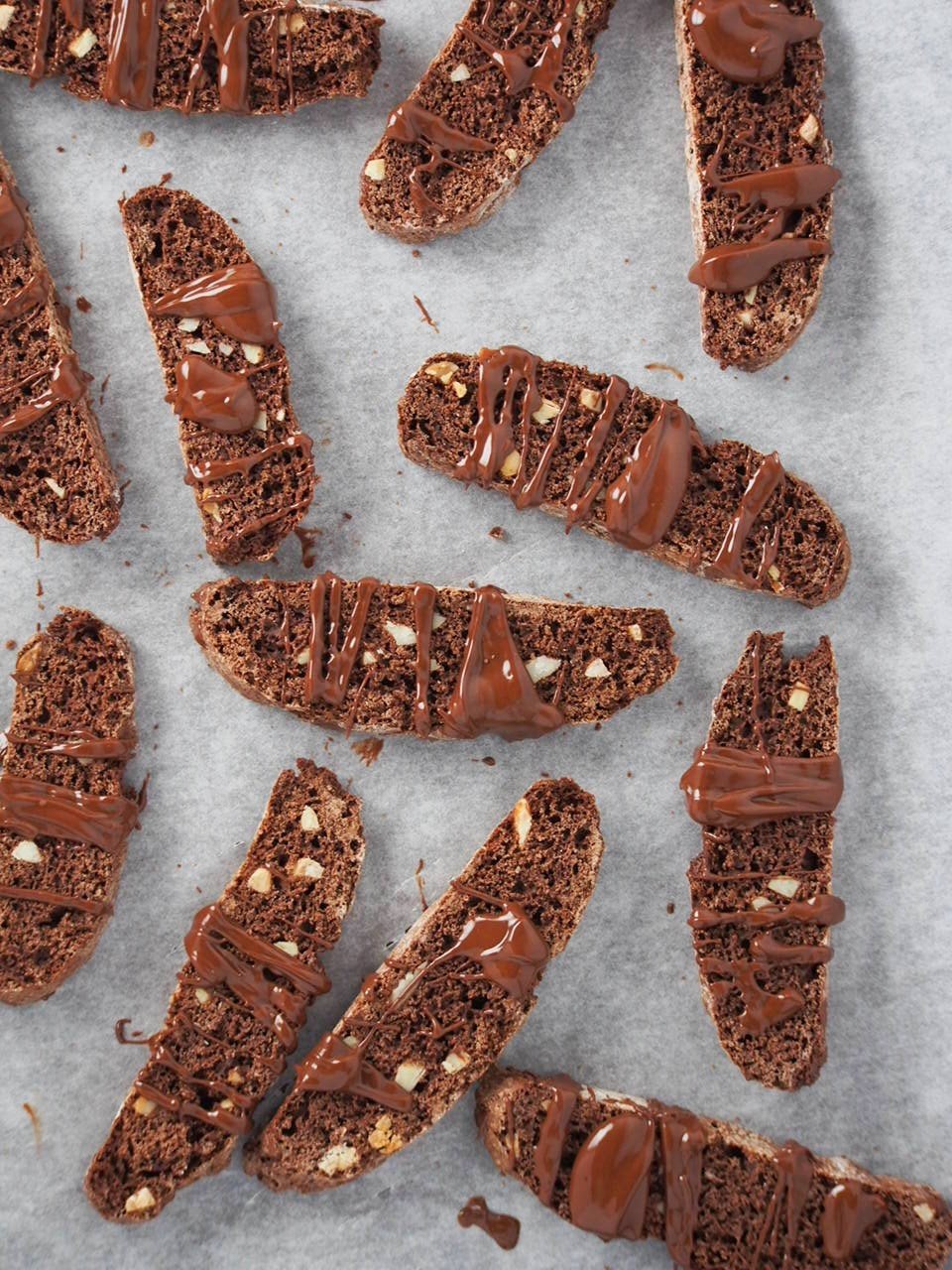 Top angle shot of chocolate almond biscotti on a parchment paper.