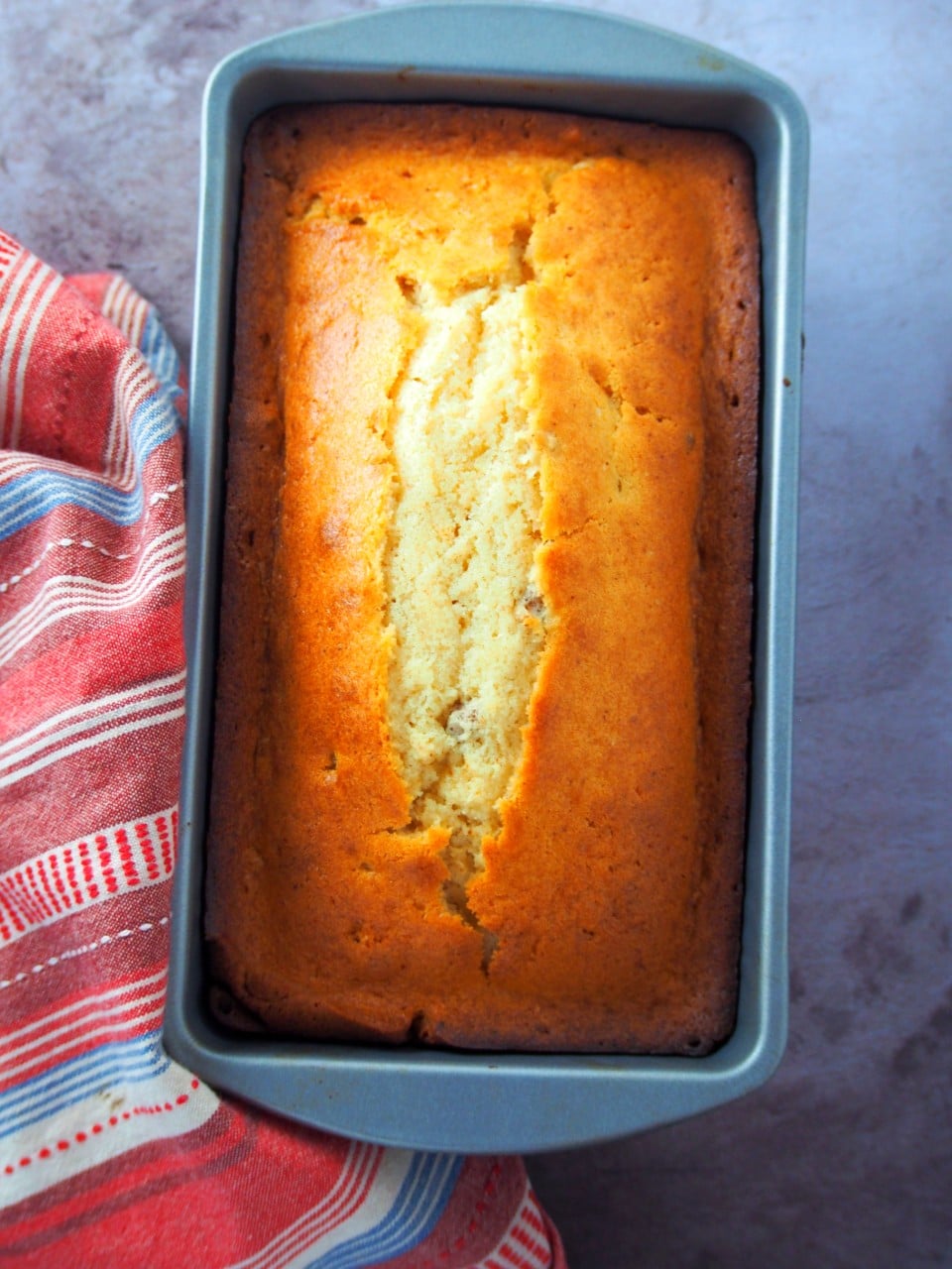 Brown butter pound cake on a cake pan.