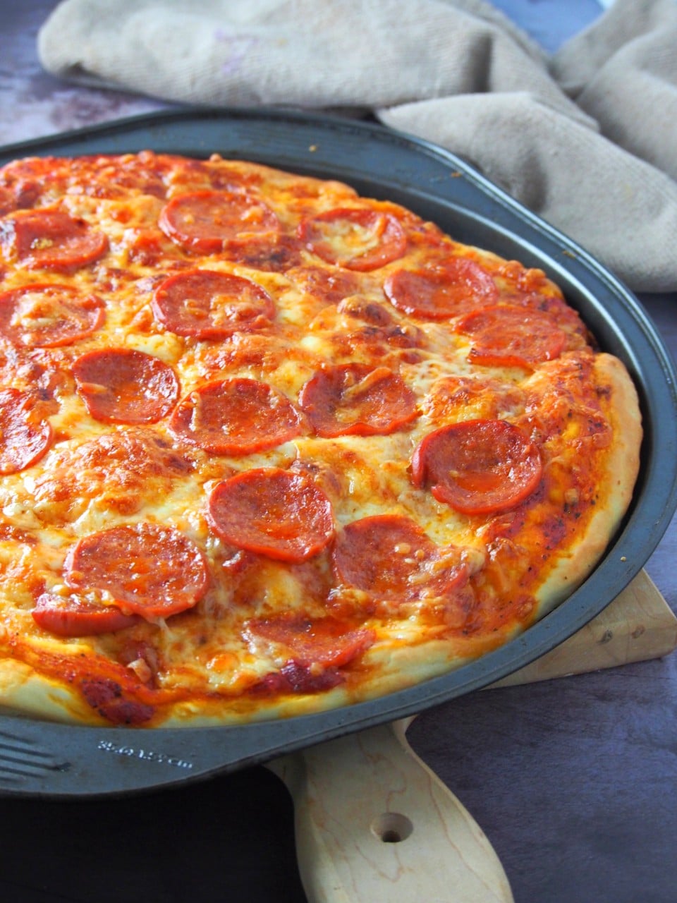 One pizza pan of homemade pepperoni pizza.
