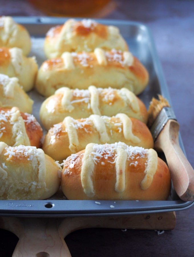 Coconut Buns with milky sweet filling on the baking tray.