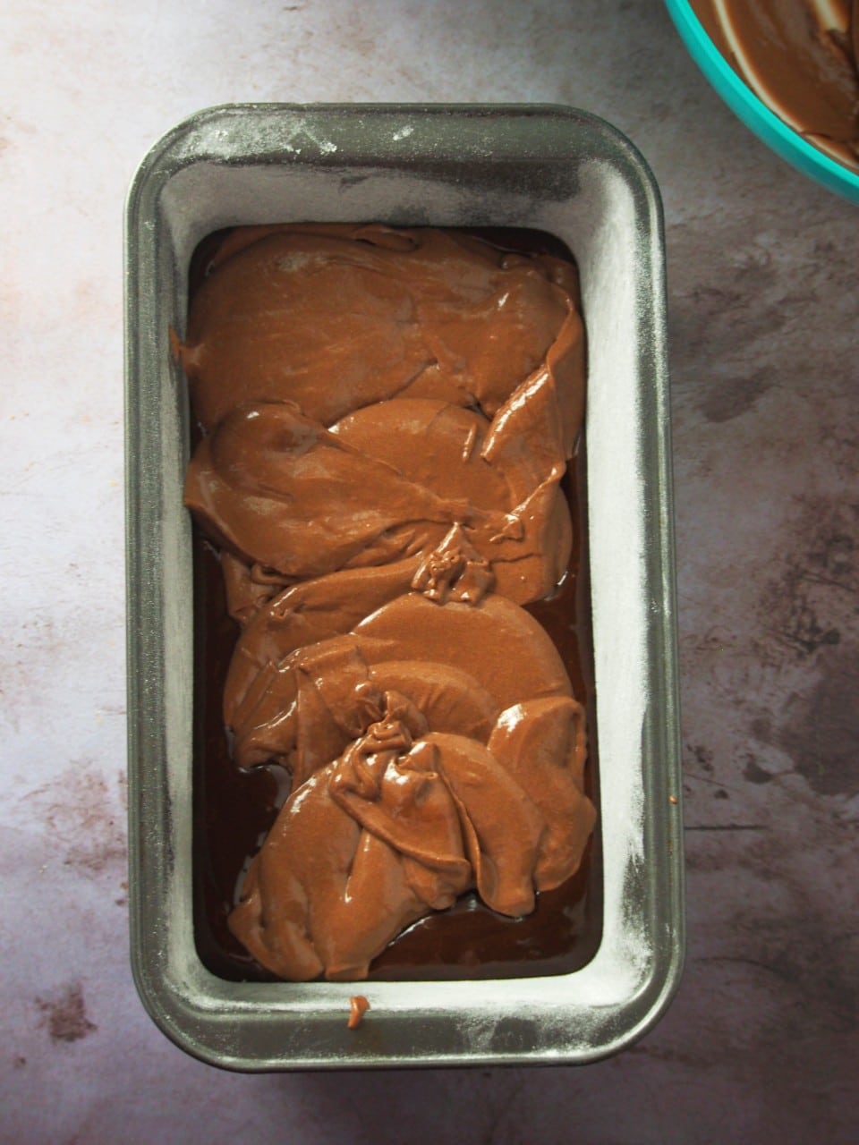 Layering of the chocolate batters in the ombre chocolate cake.