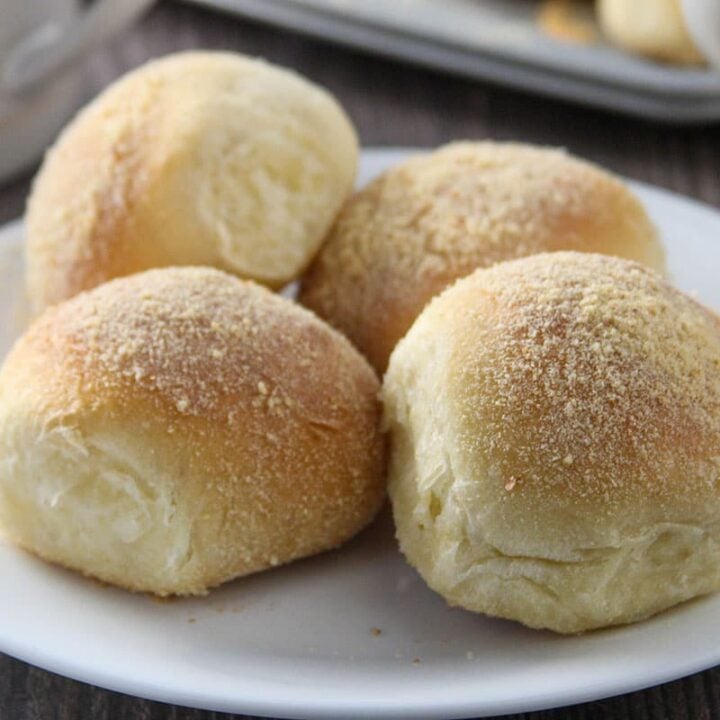 Four pandesal on a plate.