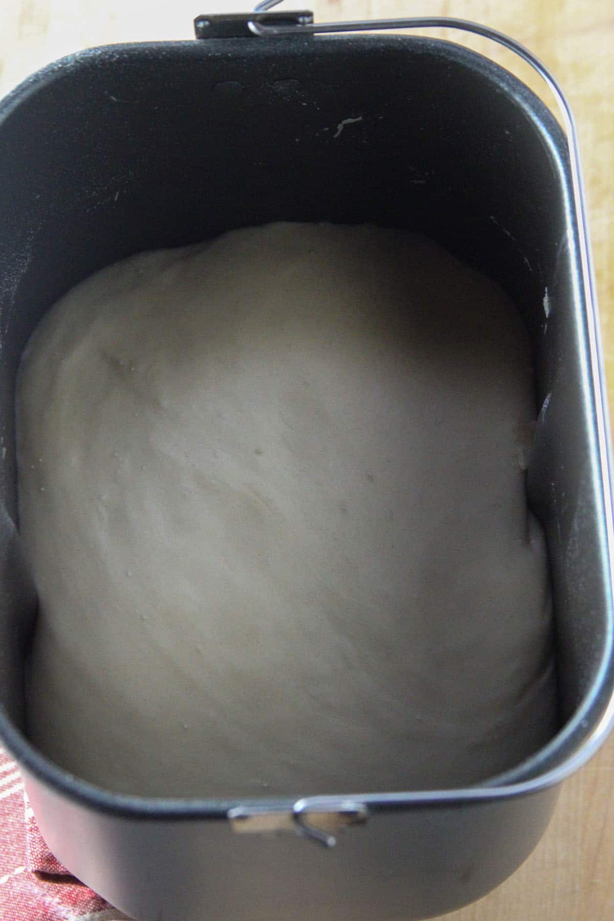 The risen pandesal dough on the bread machine.