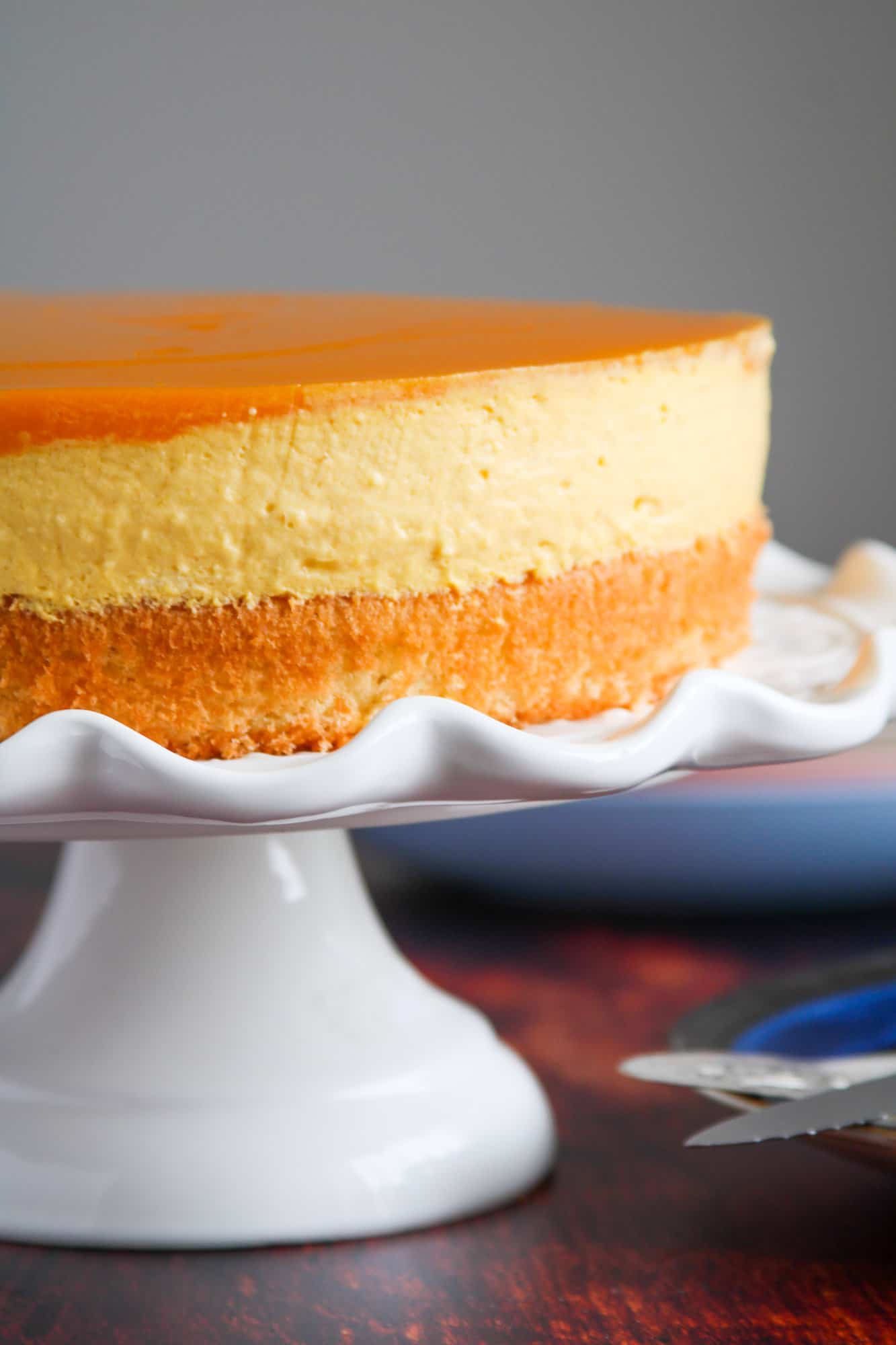 Mango mousse cake on a cake stand.