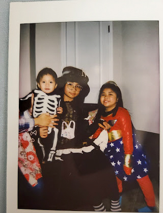 Photo of three kids in their Halloween costumes.