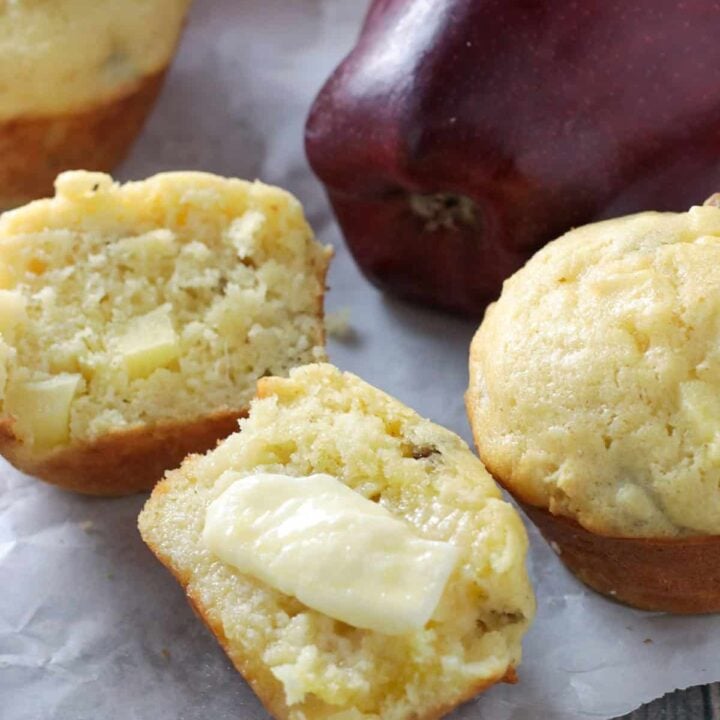 Apple Cornbread Muffin sliced in half and smeared with butter.