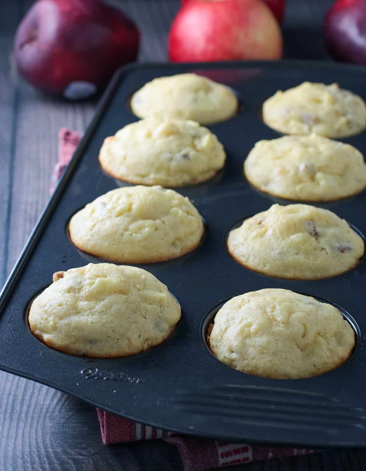 Apple cornbread muffins on a pan.
