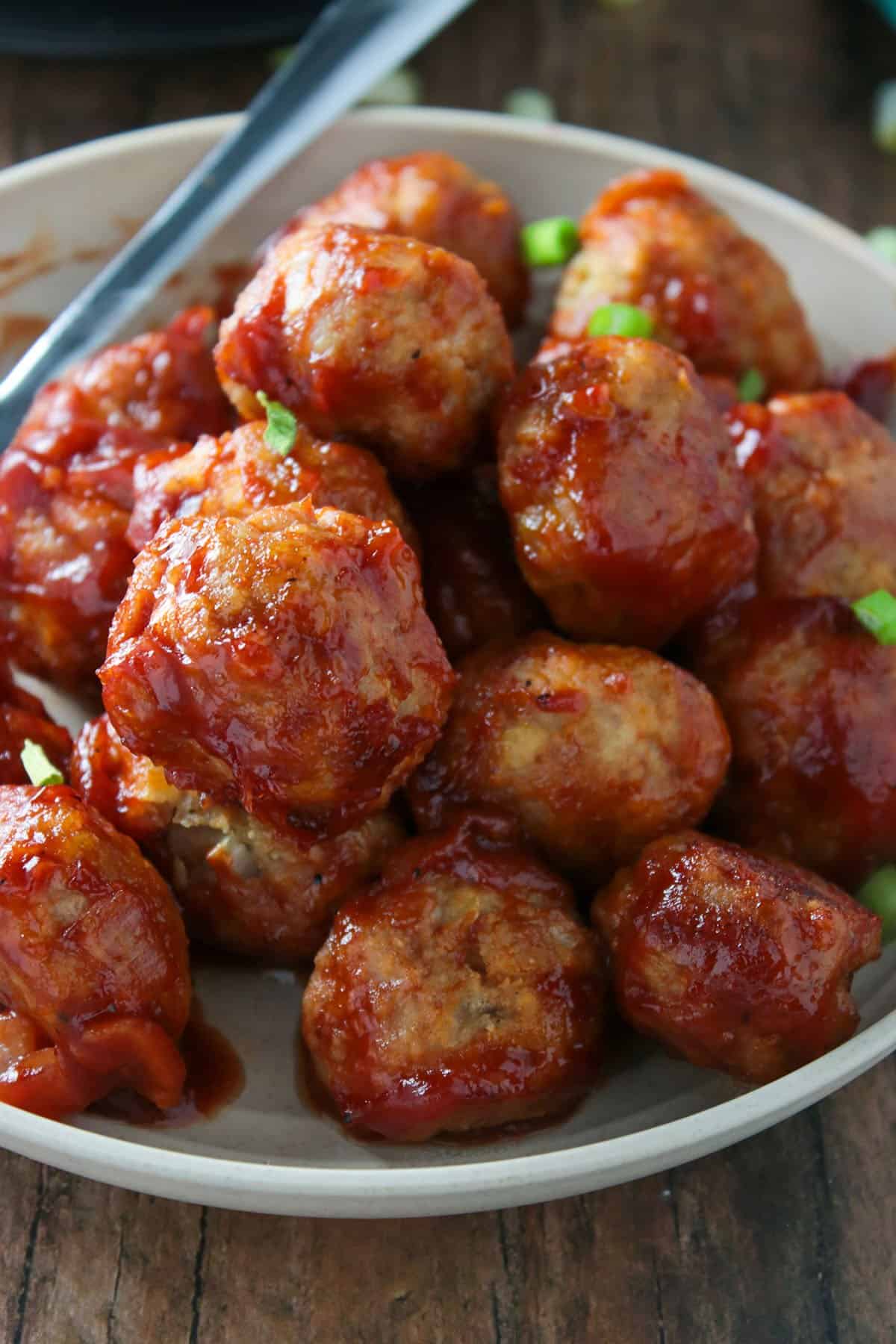Freshly baked chicken meatballs on a serving plate.