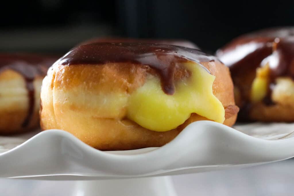 Close up shot of a Boston cream donuts  on a serving platter.