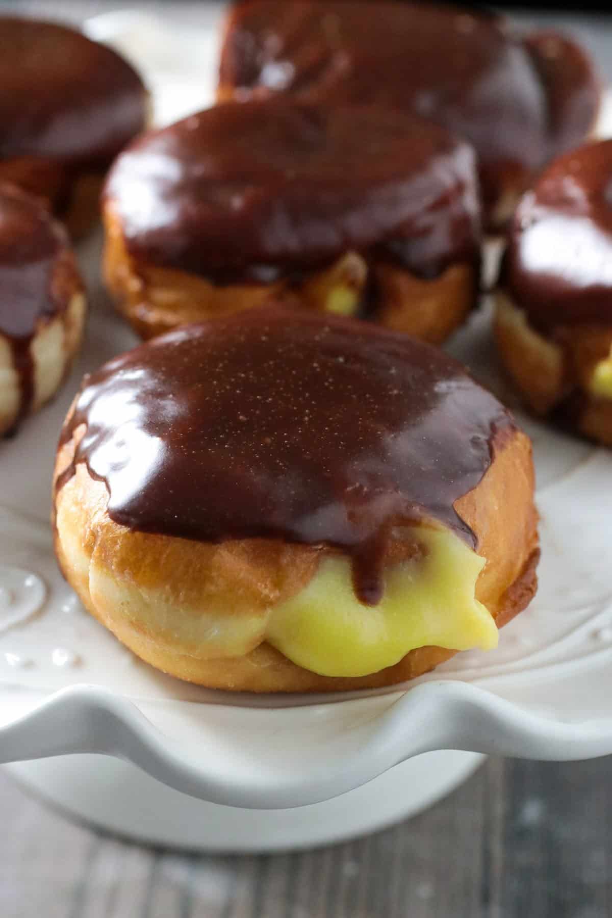 Boston cream donuts on a platter.
