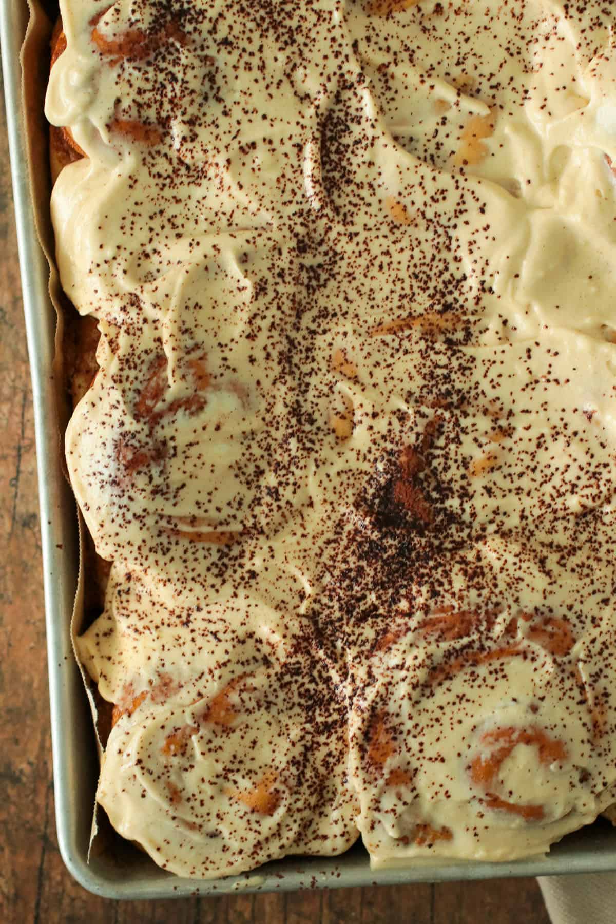 Top angle view of the coffee cinnamon rolls in a pan.
