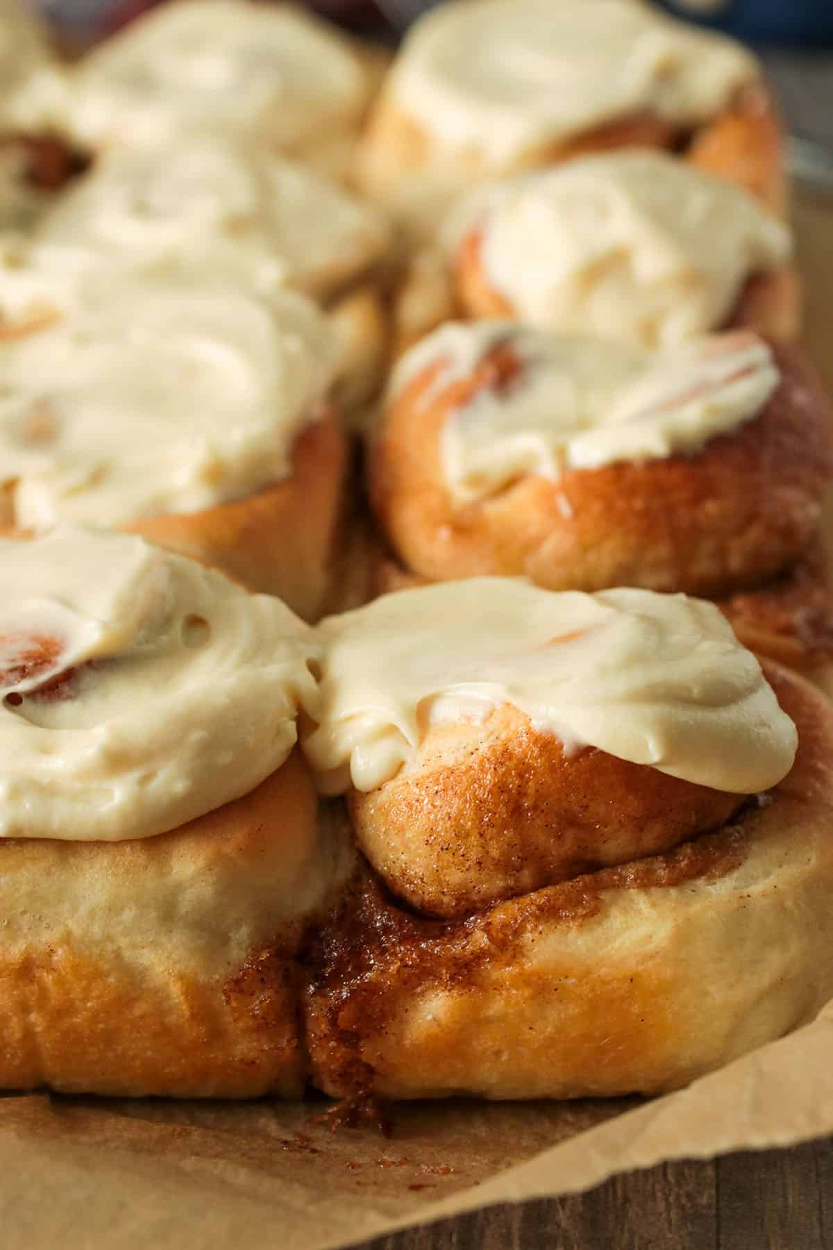 Close up shot of cinnamon rolls with maple cream cheese icing