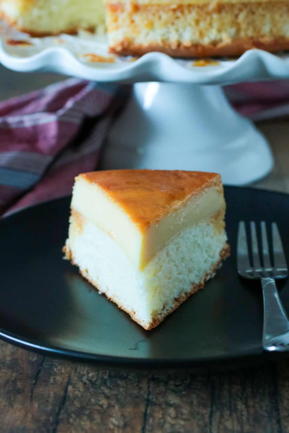 A slice of custard cake on a plate.