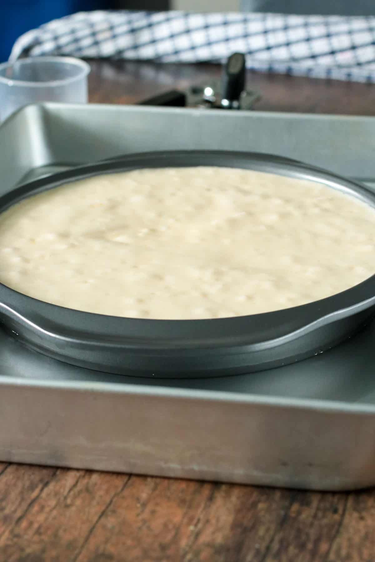 The custard cake batter in the pan, ready for baking in a waterbath set up.