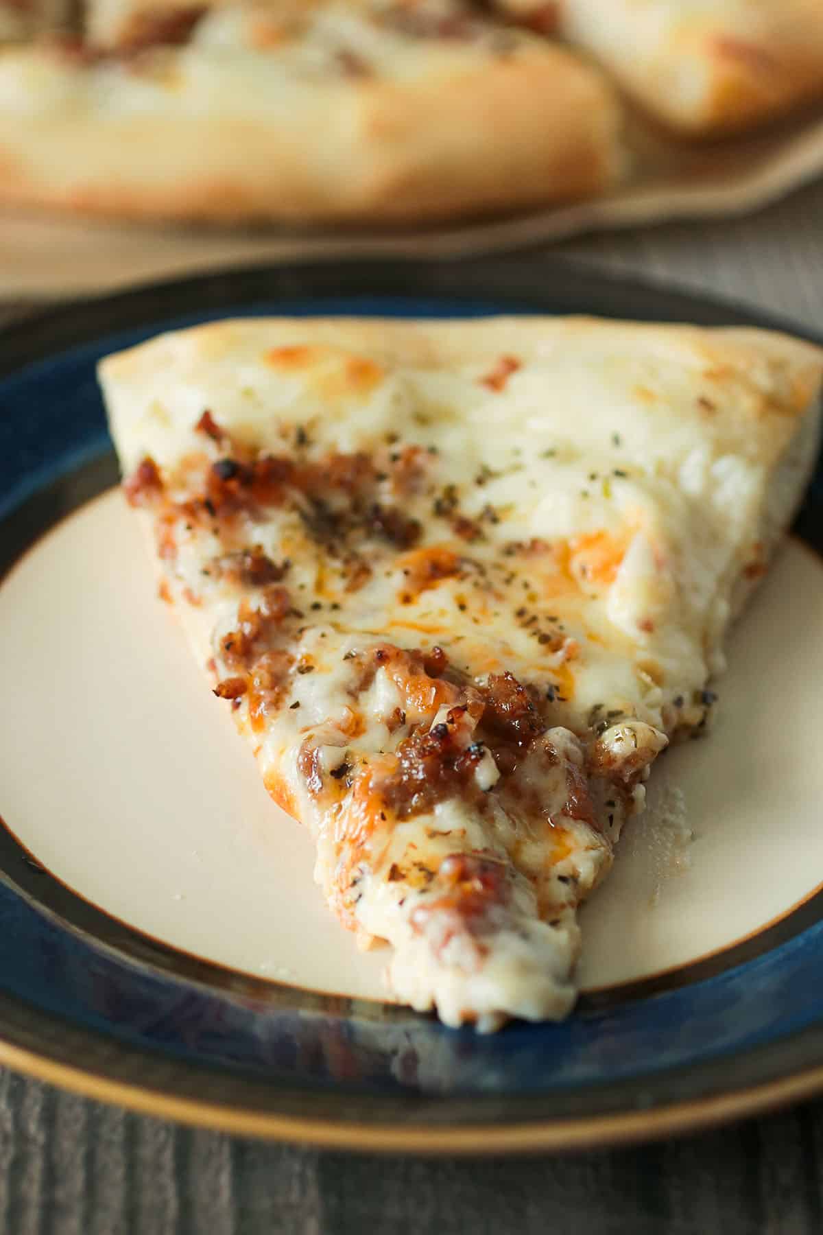 A slice of Italian sausage pizza.