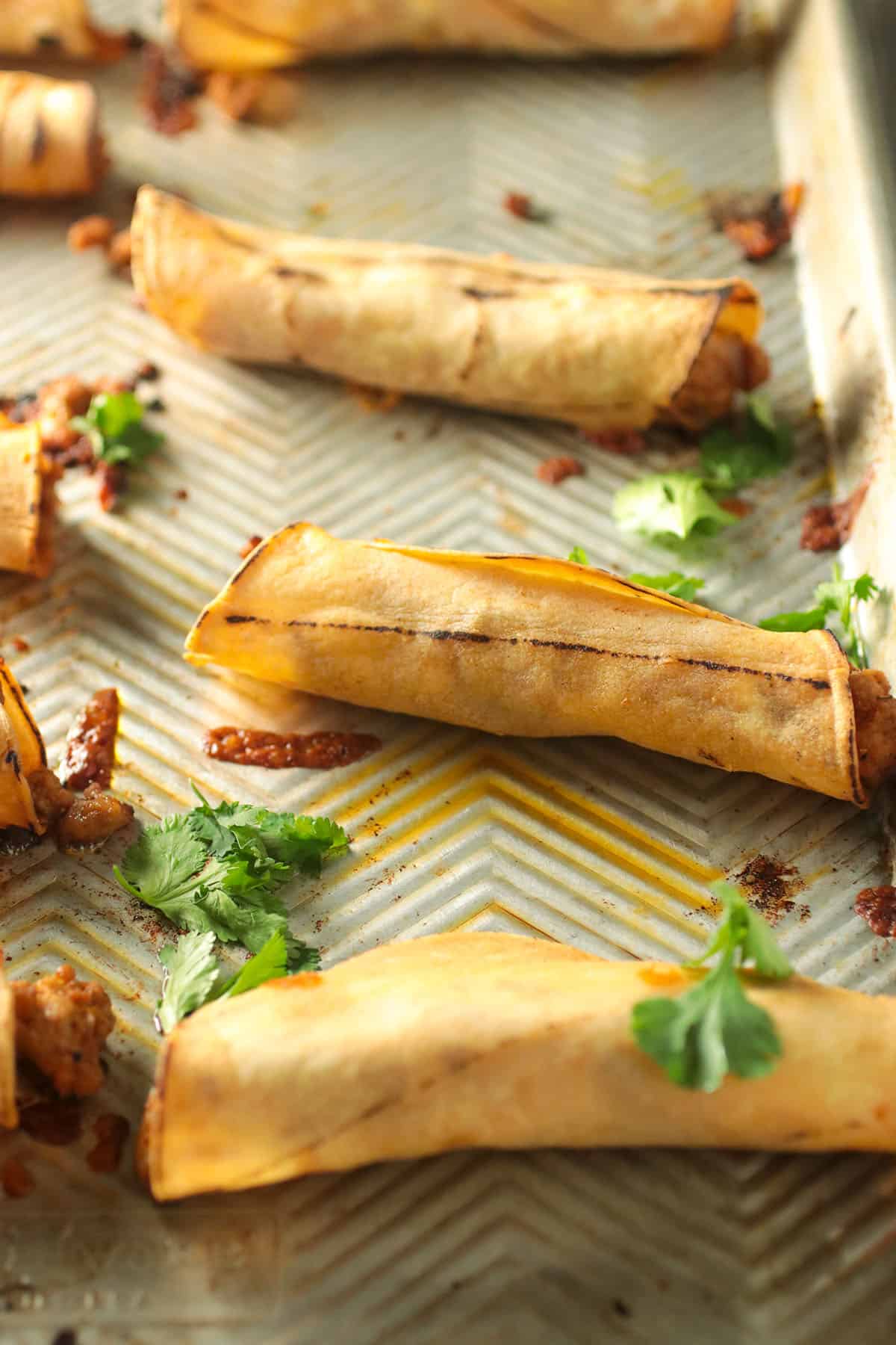 The freshly baked taquitos in the pan.