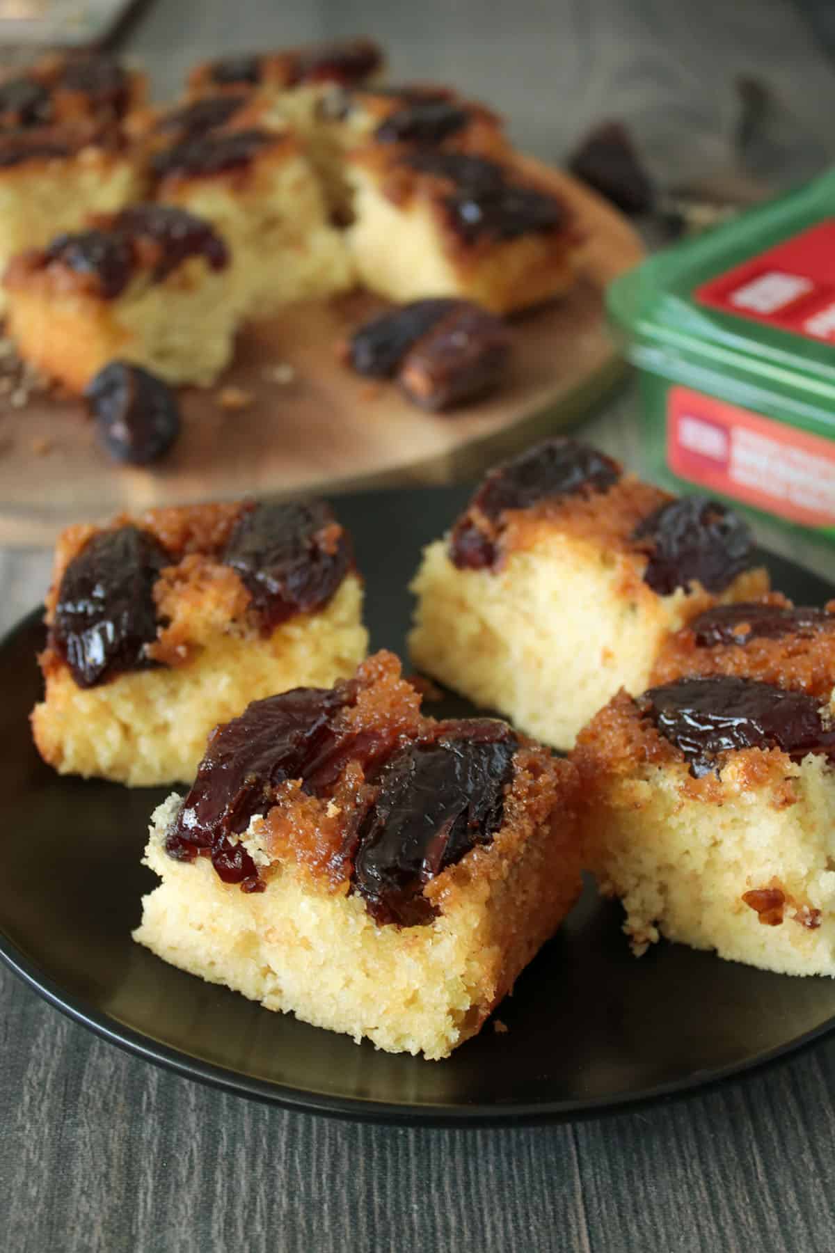 Medjool date coffee cake sliced into squares, served in a plate.