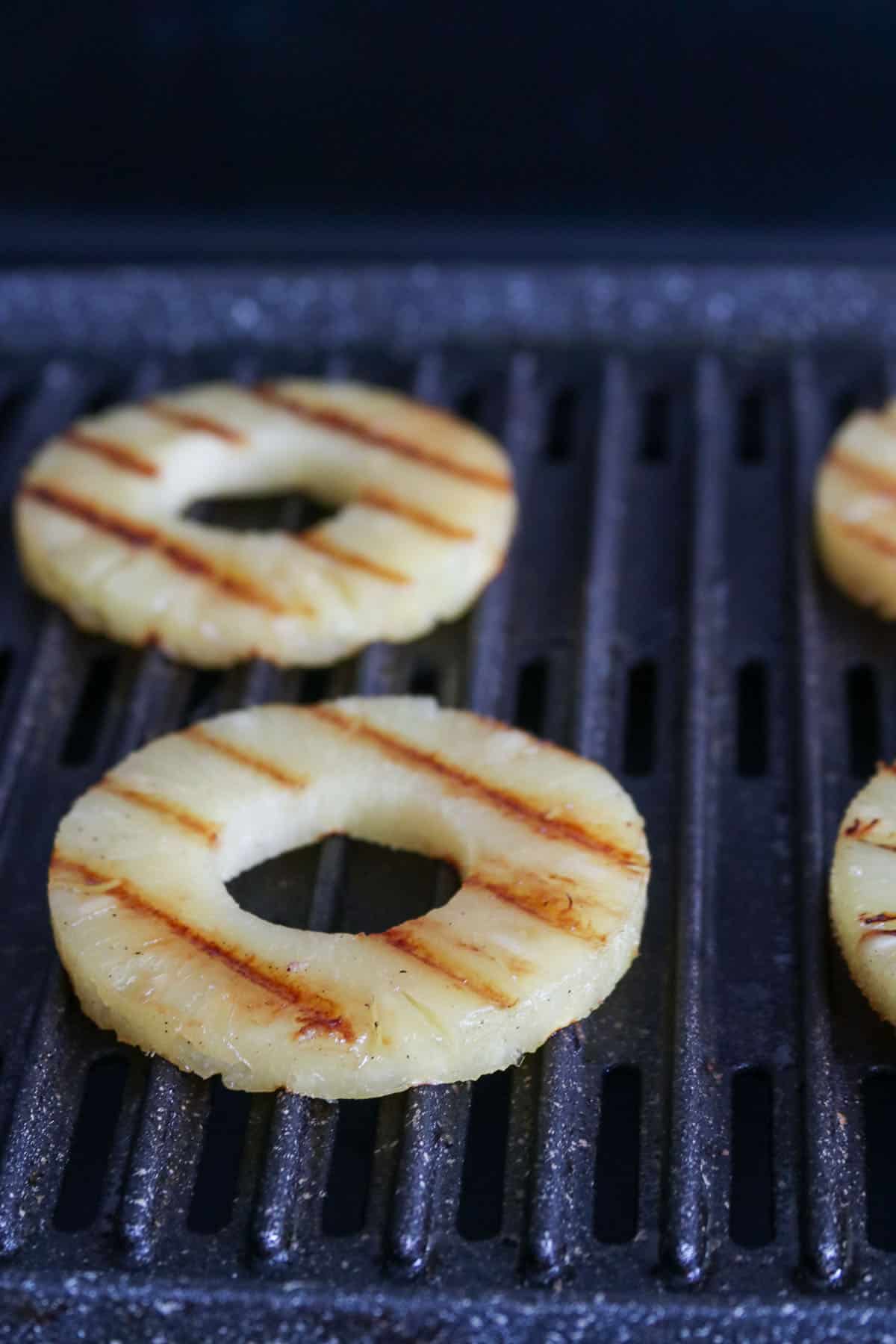 Grilling the pineapple rings.