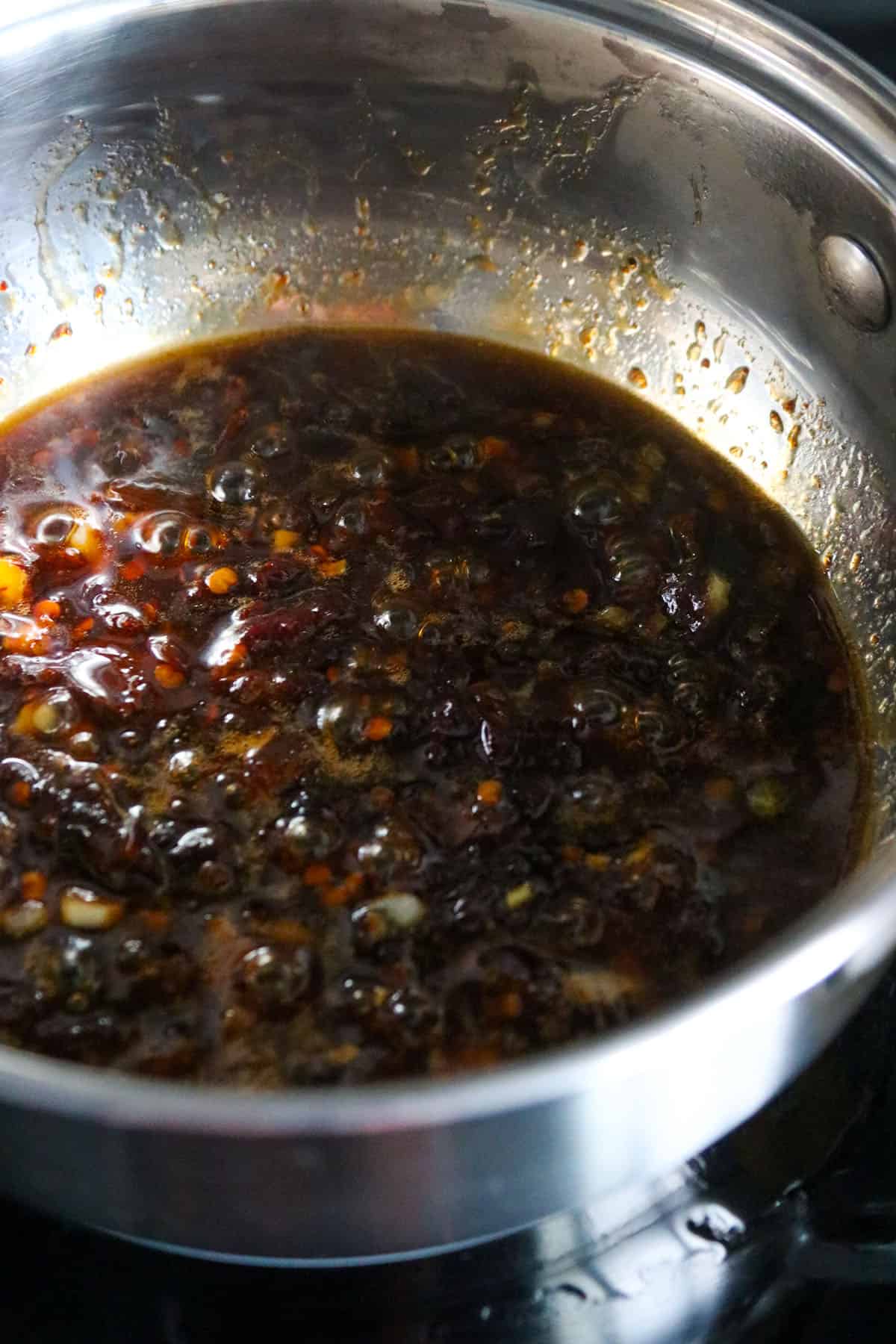 The honey chipotle sauce cooking in a saucepan.