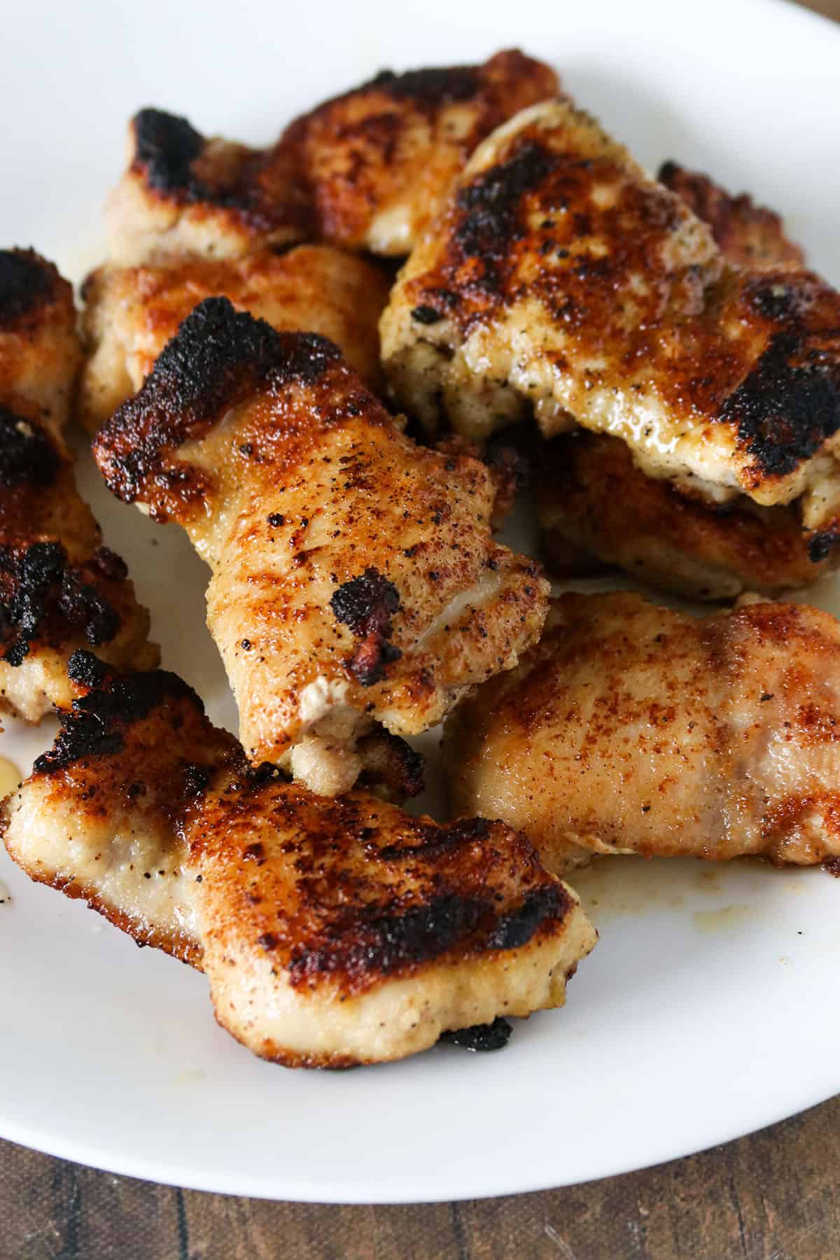 The cooked chicken thighs on a plate.