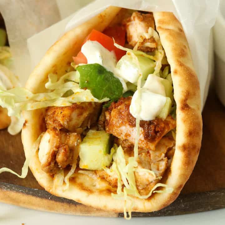 Close up of wrapped baked chicken shawarma.