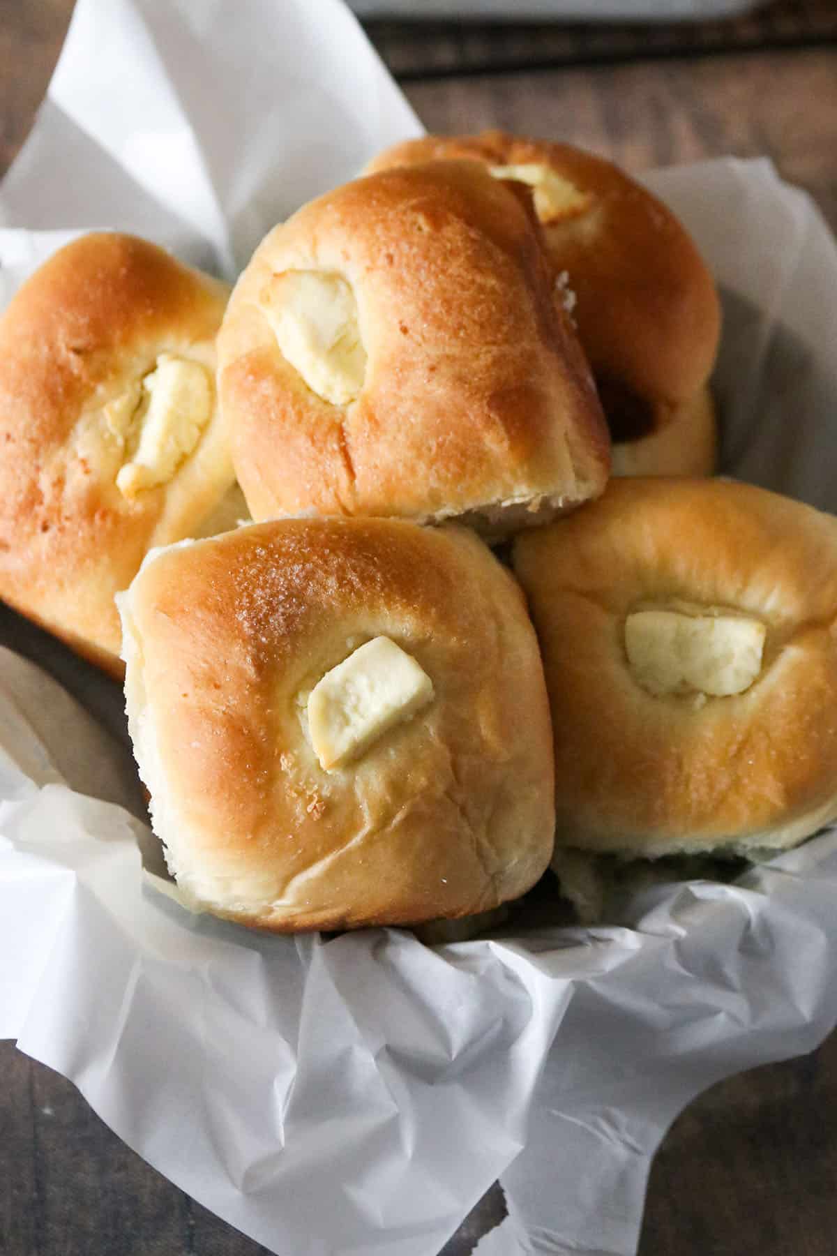 Cream Cheese bread rolls on a bread basket.