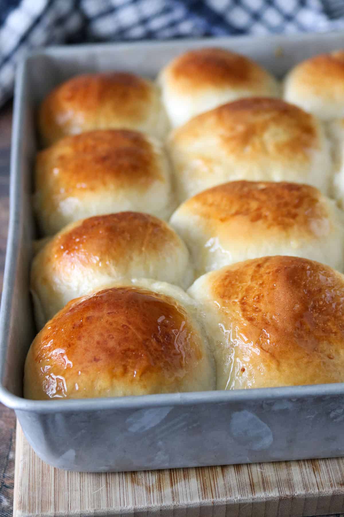 Fresh honey buns on a baking pan.