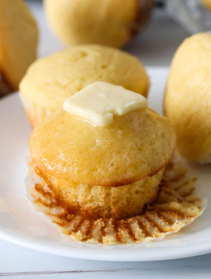 Cornbread muffin topped with butter.