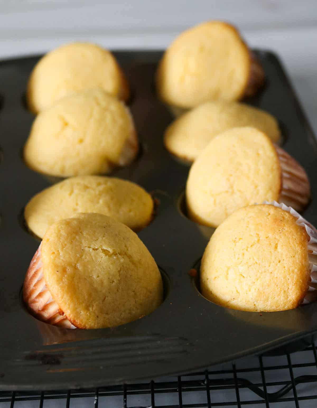 Cornbread muffins on a muffin pan.