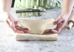 Folding the rectangle dough in thirds.