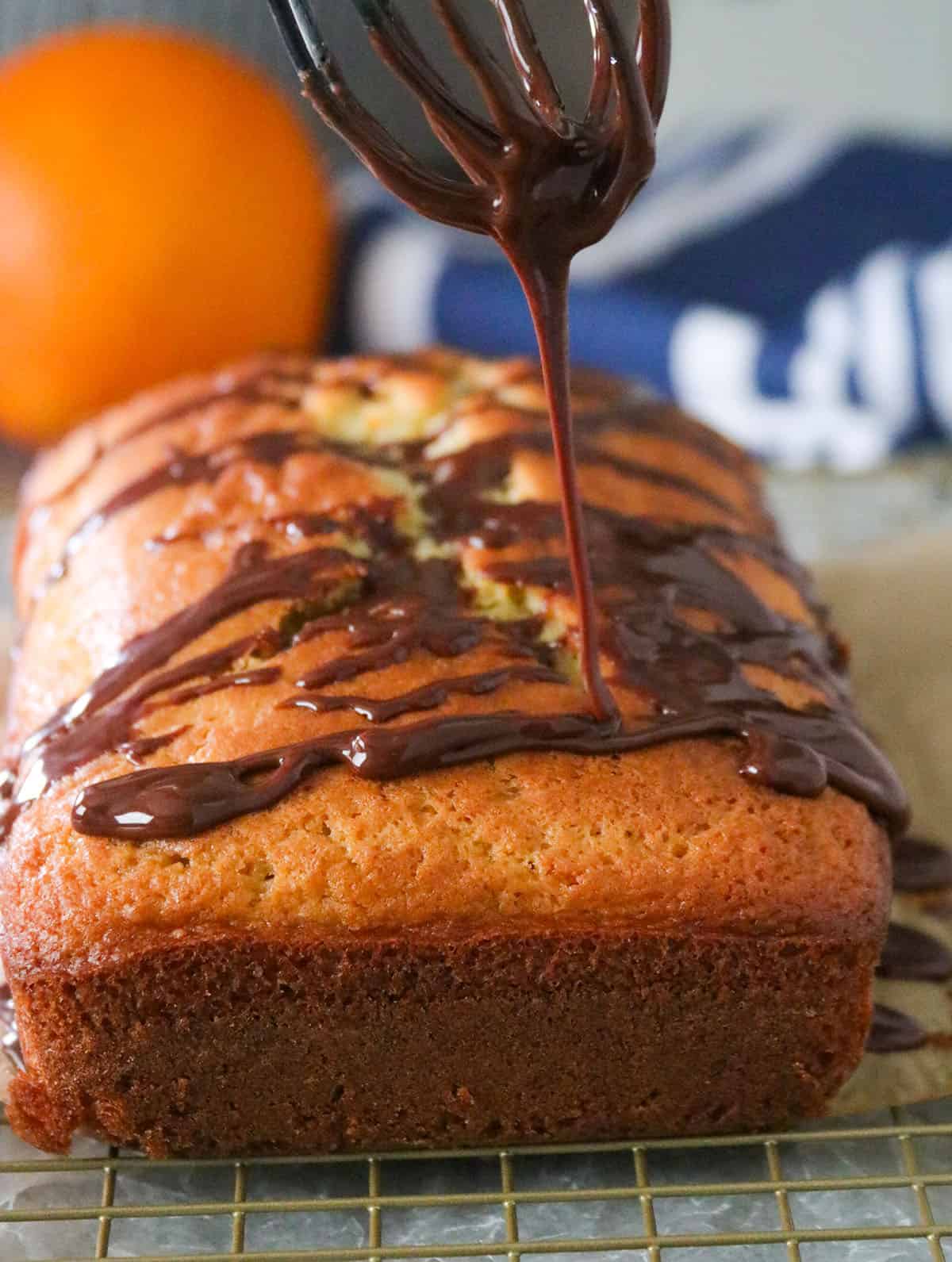 Pouring Orange Chocolate glaze to the cake.