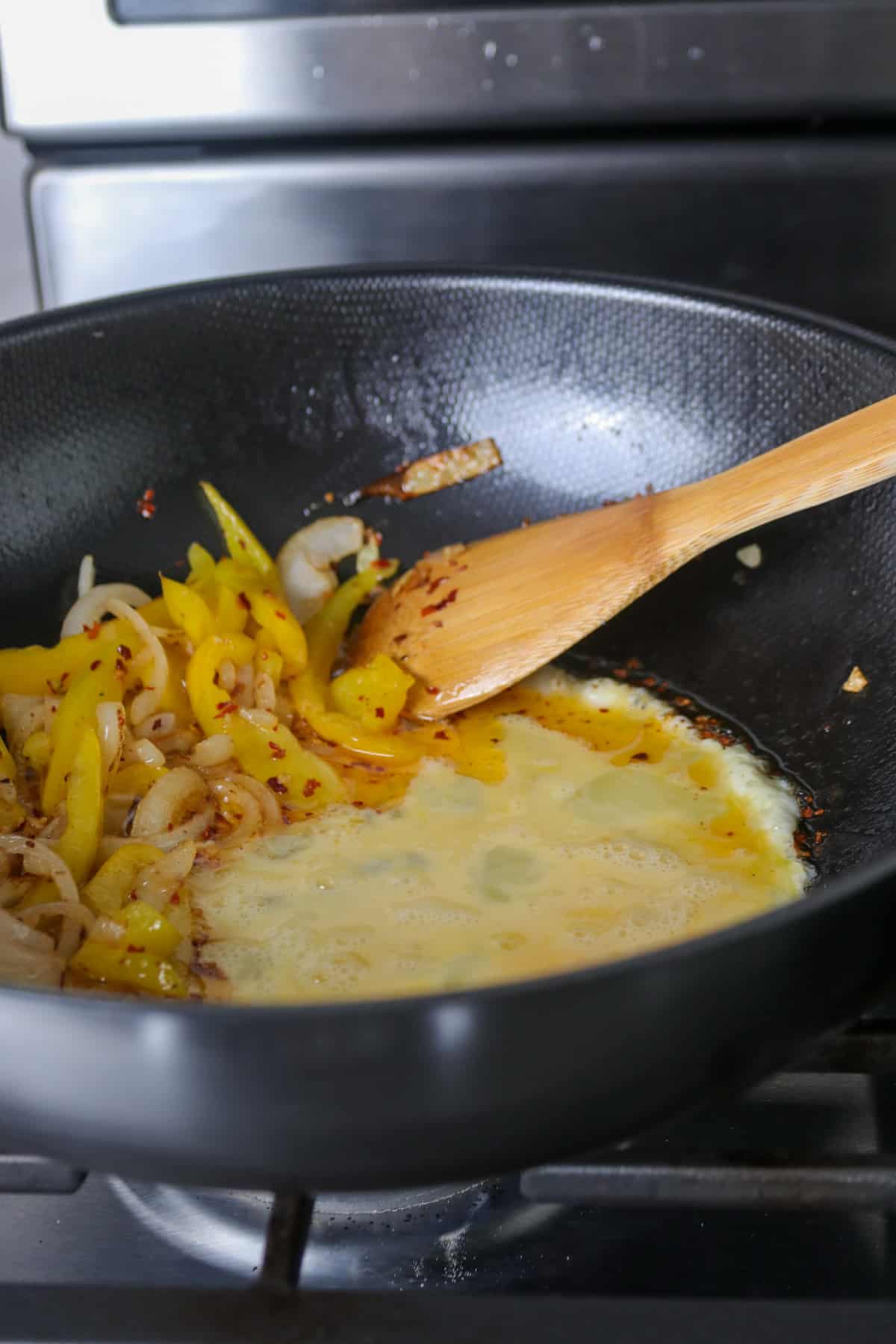 Cooking the eggs in the stir fry.