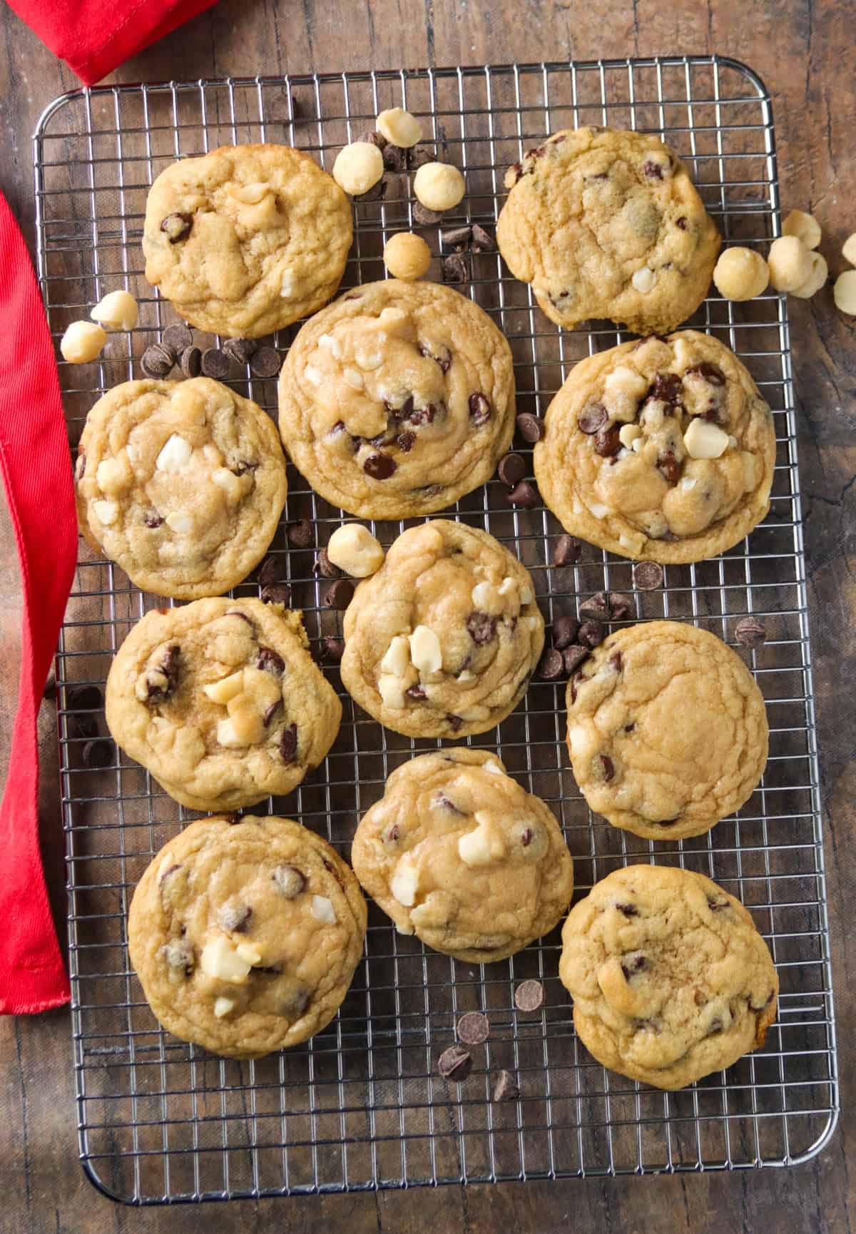 Chocolate chip macadamia nut cookies on a wire rack.