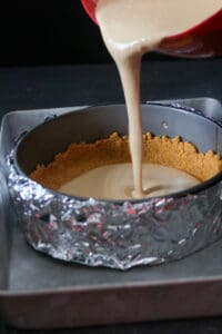 Pouring the cheesecake batter to the spring form pan.
