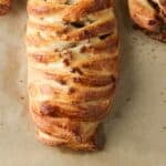 Maple pecan danish pastry on a parchment- lined baking sheet.