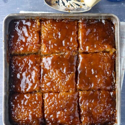 A pan of Biko sliced cut into squares in the pan.