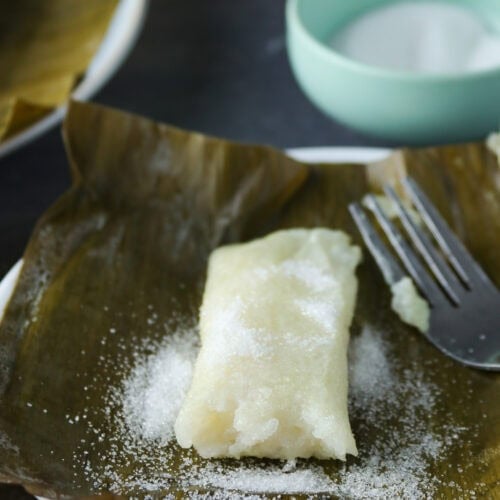 Suman in a banana leaf, dusted with sugar.