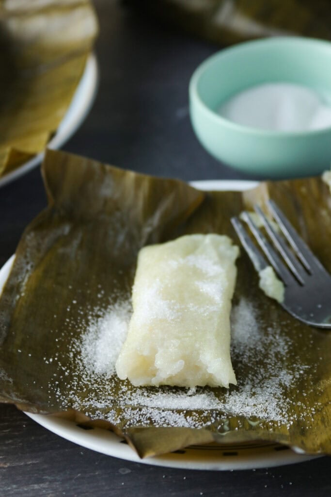 Suman in a banana leaf, dusted with sugar.